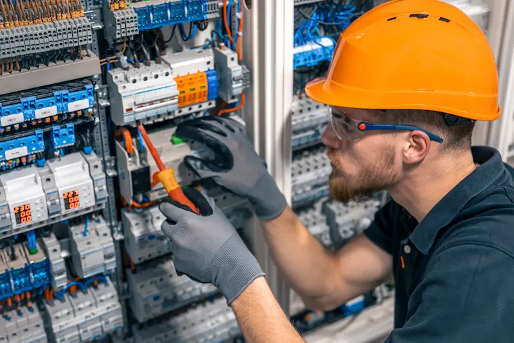 Electrician inspecting an open consumer unit