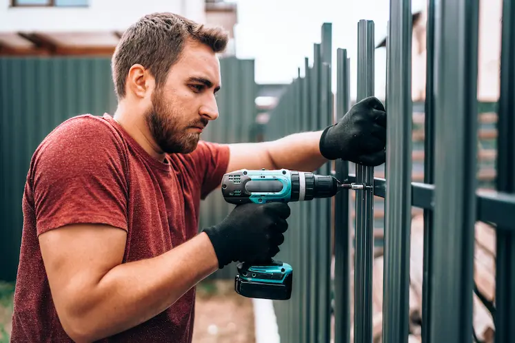 Local locksmith fitting a gate on a rural East Midlands property