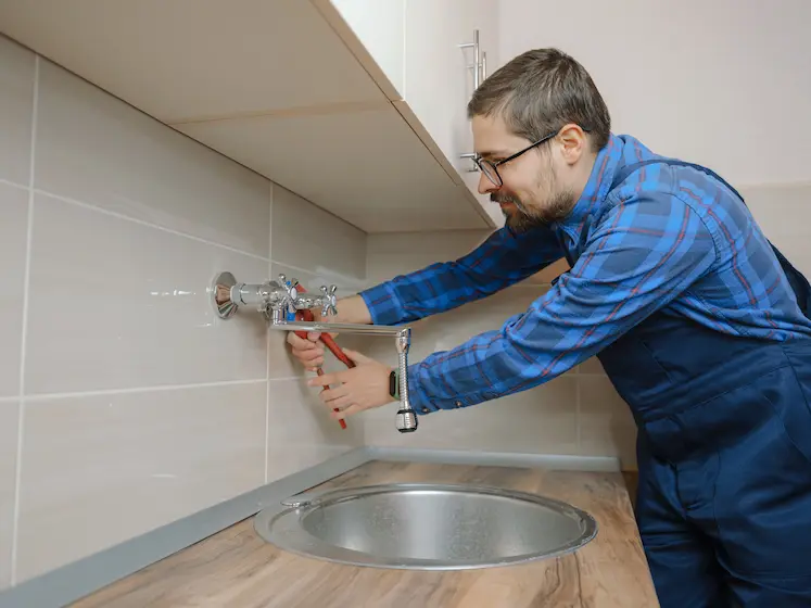 Local plumber fixing a sink tap in Worcester