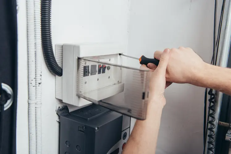 Electrician repairing an electrical panel